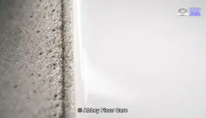 Close-up showing the difference between dense porcelain tile and porous stained grout.